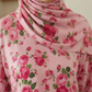 Pink floral hijab with pink roses and green leaves on a light background