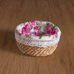 Woven basket with floral lid on a wooden surface