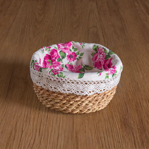 Woven basket with floral lid on a wooden surface