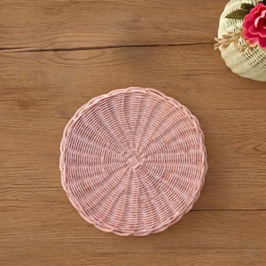 Pink woven basket on a wooden surface