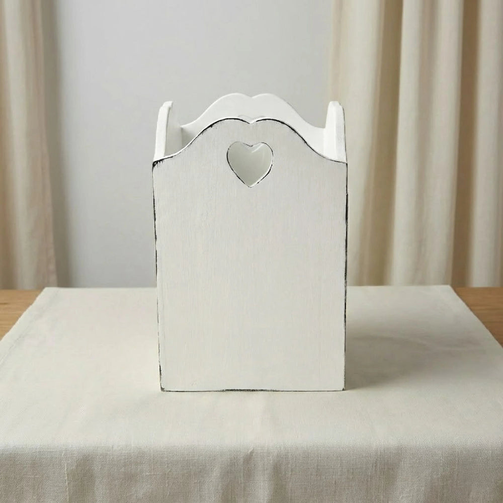 Decorative wooden box with a heart-shaped cutout on a neutral background