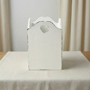 Decorative wooden box with a heart-shaped cutout on a neutral background