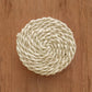 Coiled beige rope on a wooden surface