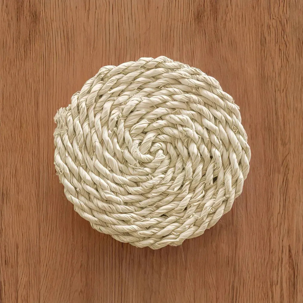 Coiled beige rope on a wooden surface