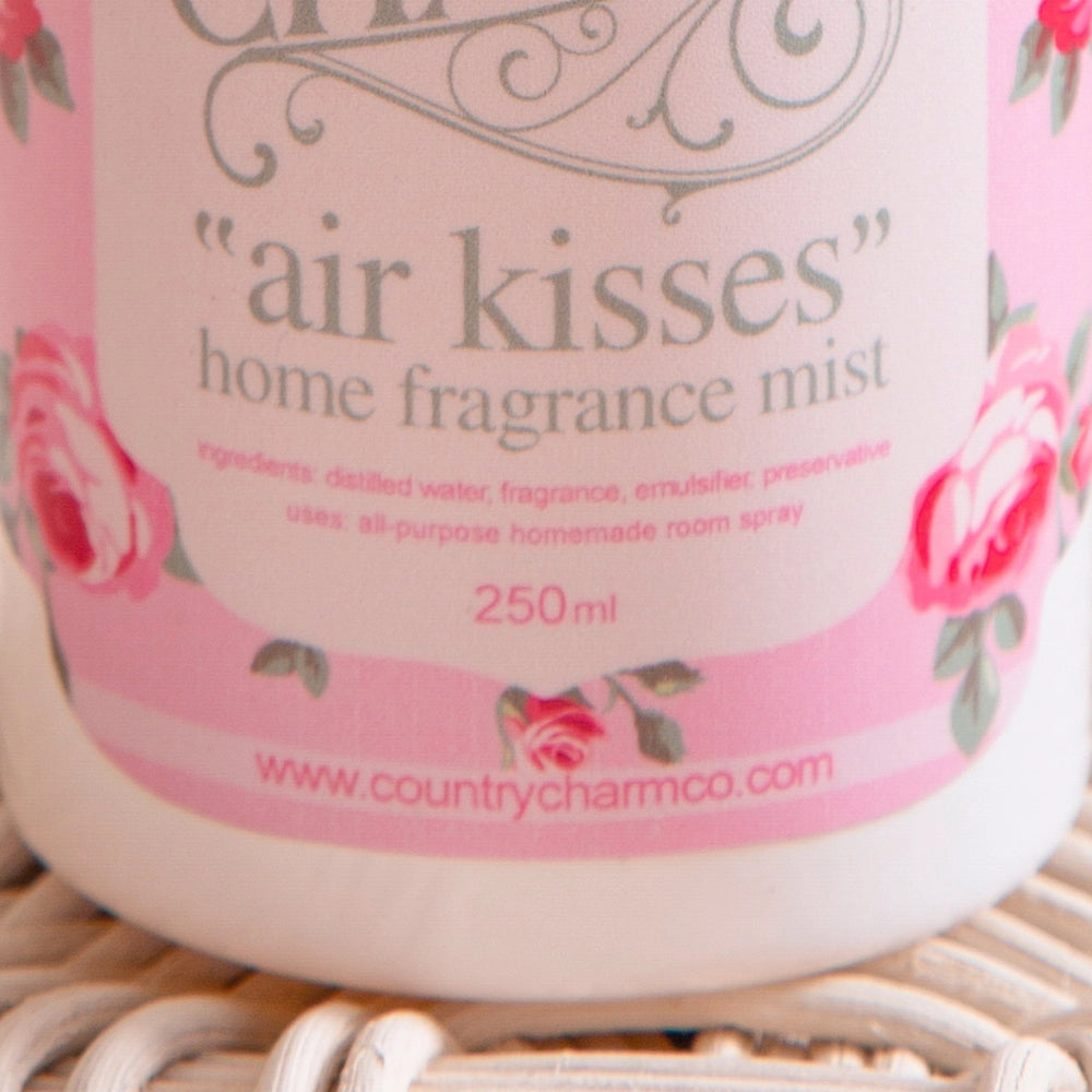 Container of 'air kisses' home fragrance mist with floral design and text.