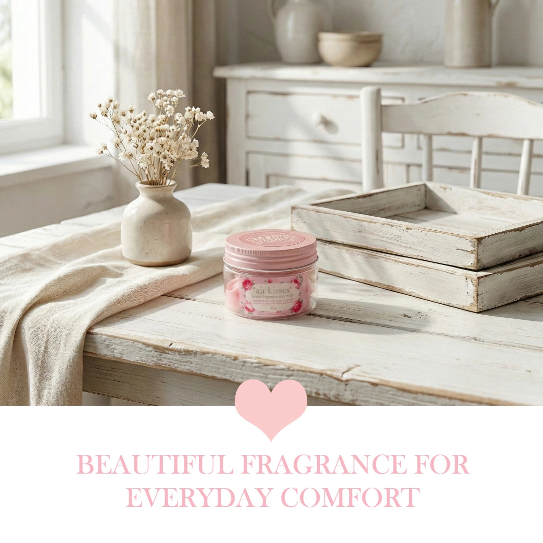 Air Kisses home fragrance soy wax melts jar on a white farmhouse dining table with a wooden tray.
