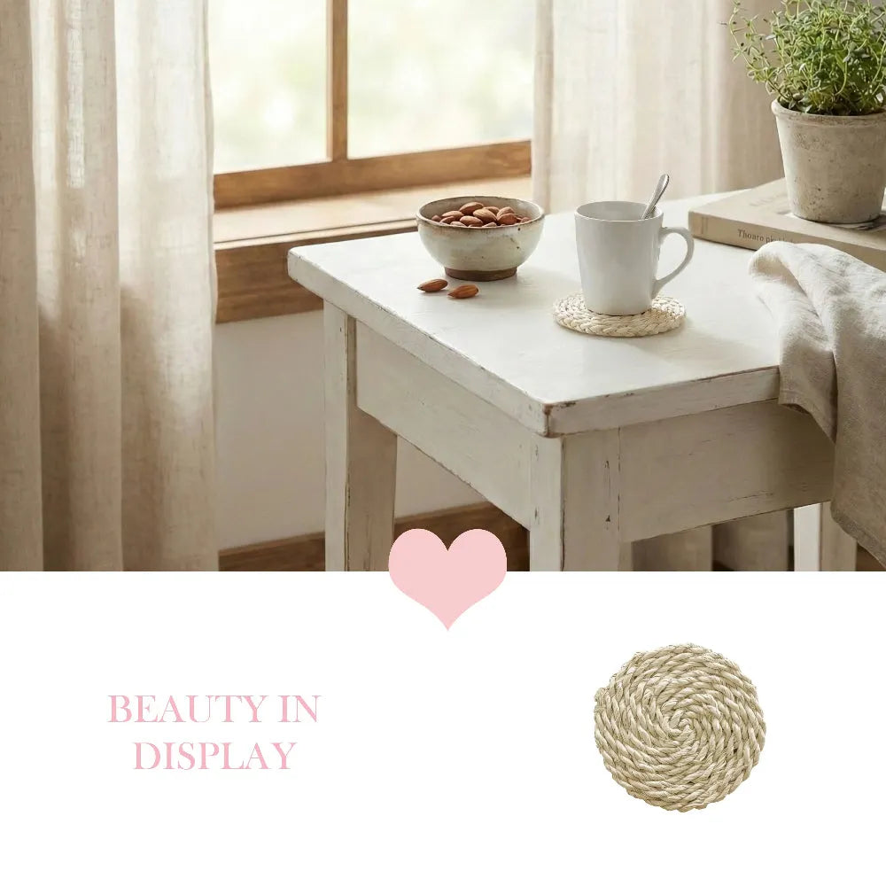 White table with a cup, bowl, and plant in a bright room.
