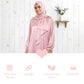 Woman wearing a pink hijab and polka dot Isdal Prayer dress against a white wooden background with text about fabric properties.
