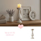 Decorative candle holder on a rustic wooden table with elegant home decor items on display.