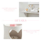 Ceramic heart-shaped candle holder with a pink candle on a white surface, with text about Country Scent Haven and heart cut-out pottery.


