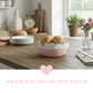 Cottage Round Wicker Basket of bread on a wooden table with decorative elements in a kitchen setting