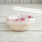 Cottage Round Wicker Basket with floral fabric lining on a wooden surface