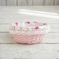 Cottage Round Wicker Basket with floral lace linen lining displayed on wooden surface