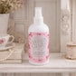Country Charm Air Kisses Home Fragrance mist displayed with flowers and books on decorative surface