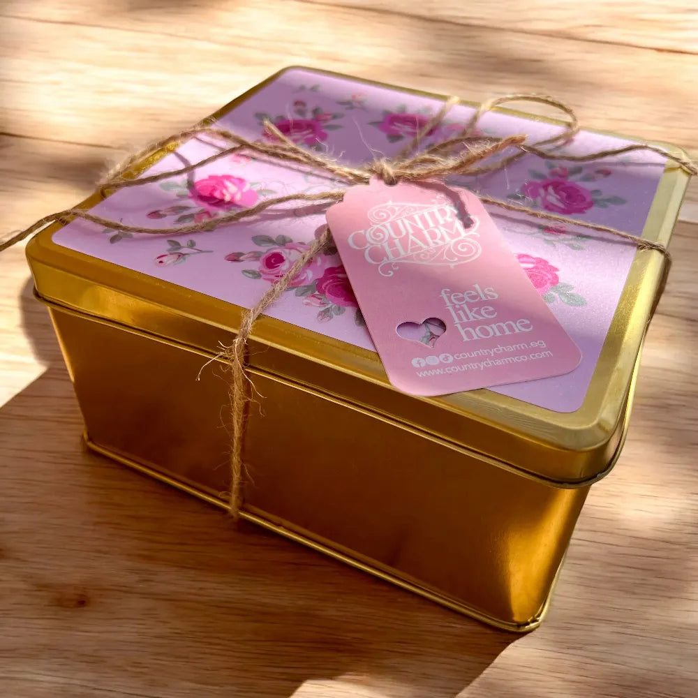 Country Charm Signature Rosie Tin Box Eid treats decorative gold box with floral lid and pink tag on wooden surface