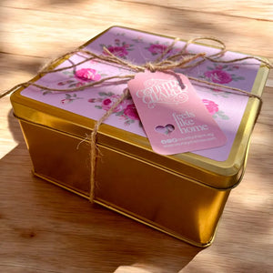 Country Charm Signature Rosie Tin Box Eid treats decorative gold box with floral lid and pink tag on wooden surface