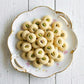 Country Charm Signature Ghorayeba Cookies with pistachios on white wooden surface Eid treats
