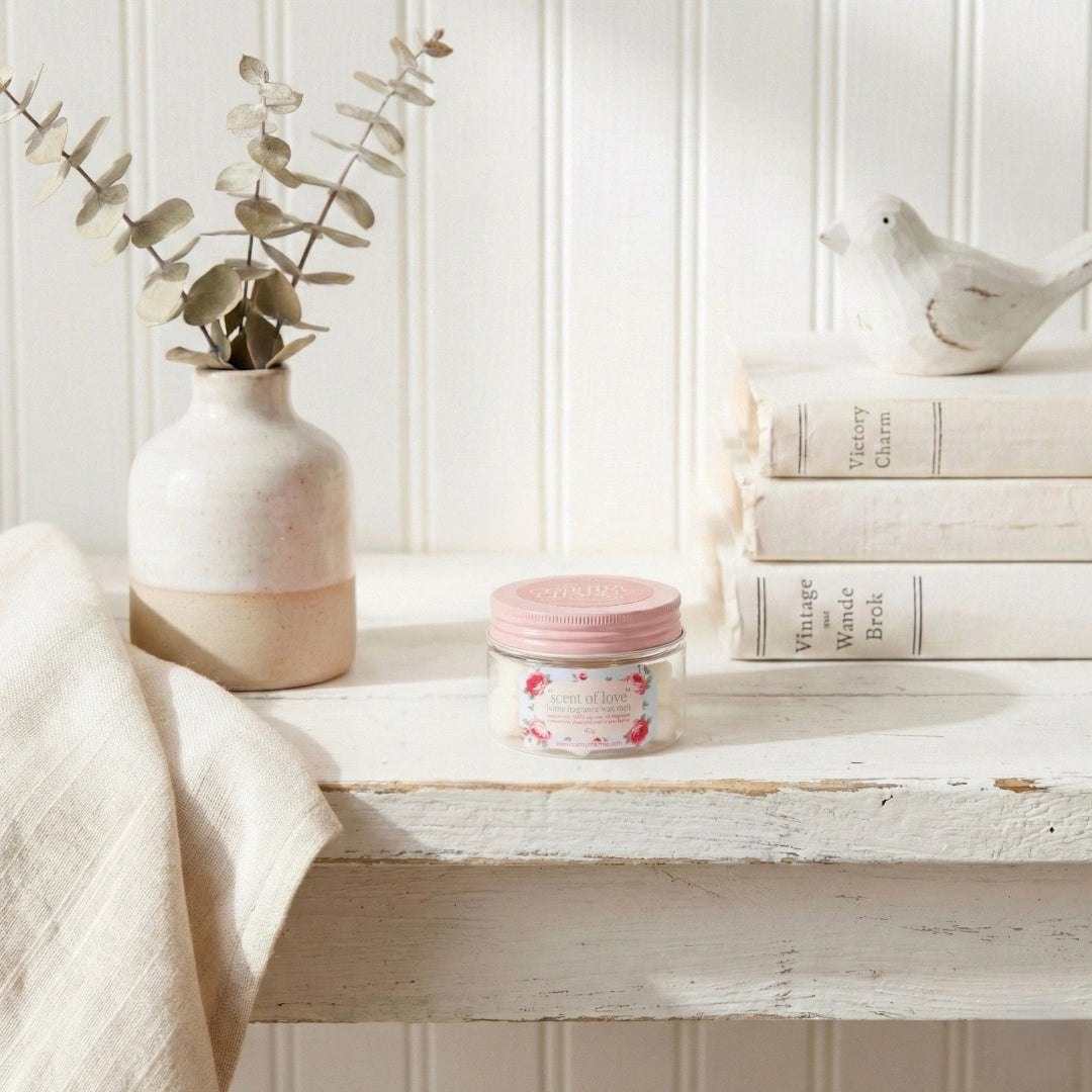 Country Charm Signature Scent of Love soy wax melts jar on distressed white wooden shelf with books