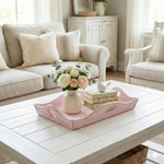 Decorative tray with flowers and books on a coffee table in a living room.