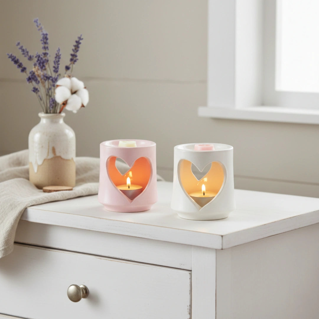 Country Heart Cut-Out Wax Melter set with lit candles, flowers on white surface