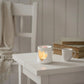 Country Heart Cut-Out Wax Melter pale pink on table beside cup with blurred books background