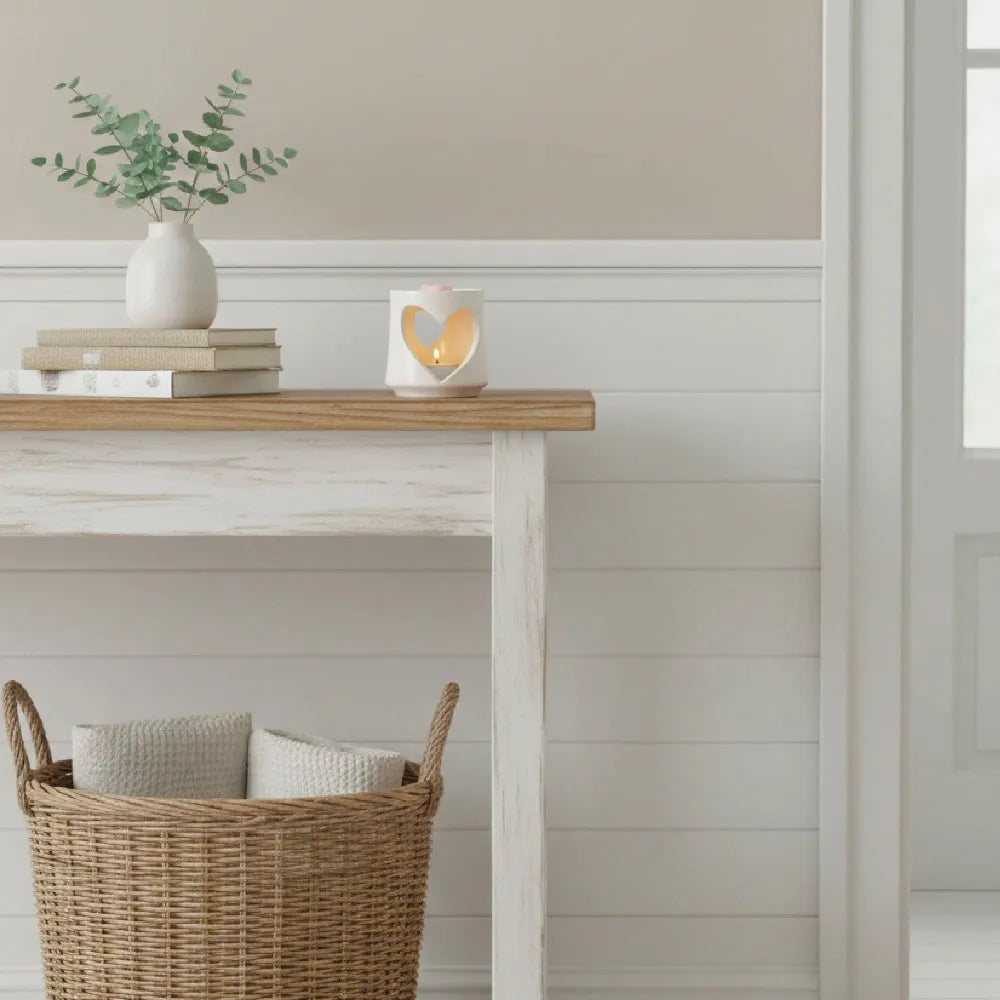Country Heart Cut-Out Wax Melter white heart-shaped design with lit candle books eucalyptus vase wooden console