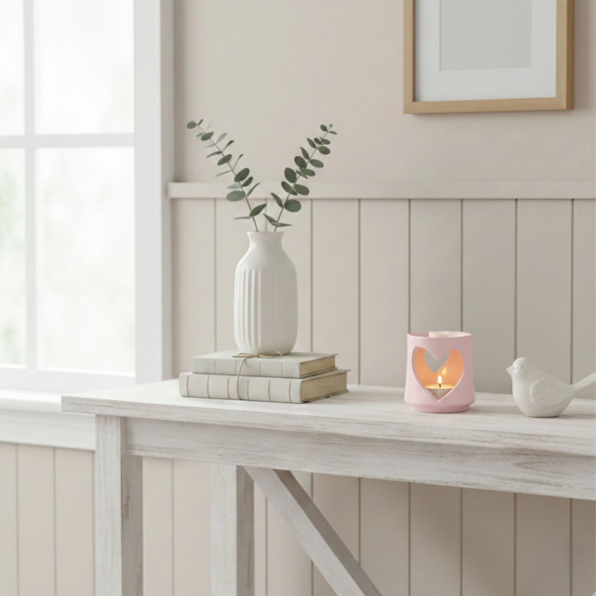 Decorative items on a table with a neutral wall background

