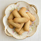 Decorative plate with cookies on a light wooden surface