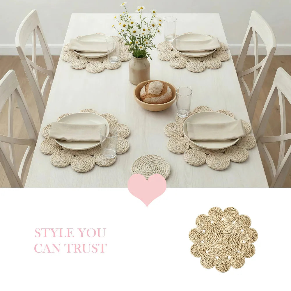 Dining table set with decorative placemats, bread, and glasses on a white tablecloth.