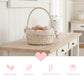 Wicker basket with decorative elements on a wooden table in a kitchen setting