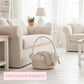 Wicker basket with floral pattern on a light wooden floor in a bright living room.