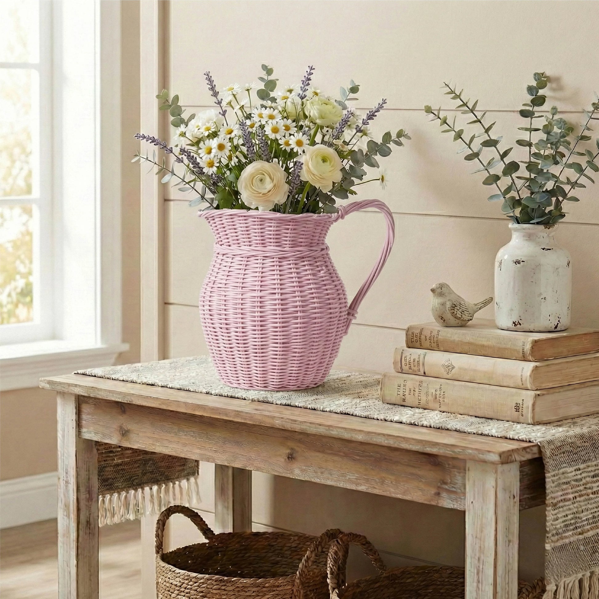 Pink woven pitcher with flowers on a wooden table in a home setting