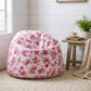 Fleur Bean Bag with floral pattern beside table and plant in living room