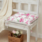 Fleur Chair Cushion floral design placed on wooden bench with basket of flowers