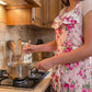 Fleur Country Kitchen Apron worn while cooking in kitchen showcasing floral design