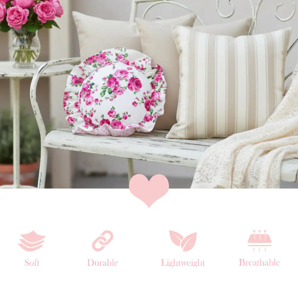 Antique white circular floral pillow on a metallic outdoor bench with decorative elements and text icons.