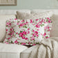 Antique white rectangular floral pillow on a sofa with a soft focus background