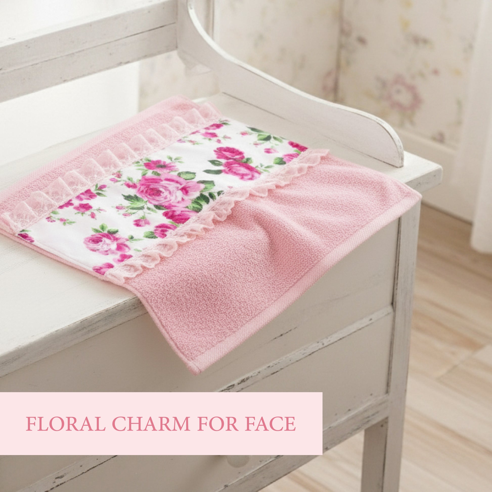 A pink face towel with a floral fleur print and lace detailing on dressing with text floral charm for face