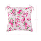 Floral-patterned cushion with pink roses on a white background