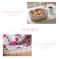 Fleur Halfa Oval Basket with floral lining on table beside coffee and flowers