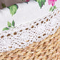 Close-up of a woven basket with a floral-patterned fabric background