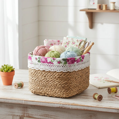 Woven basket with floral lace trim containing yarn and knitting tools on a wooden surface.