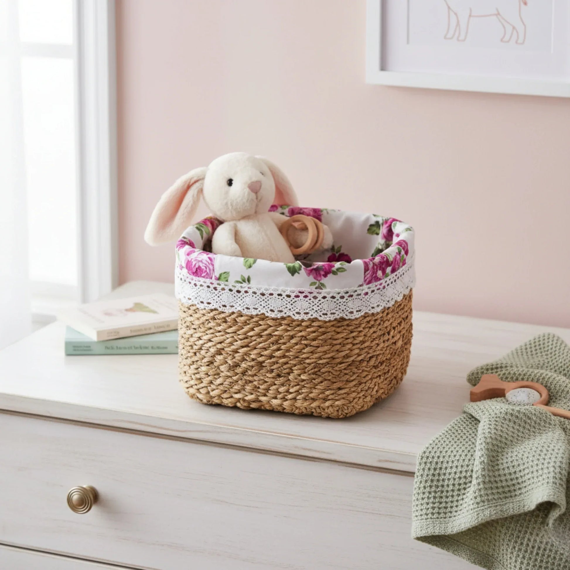 Woven basket with floral liner containing a plush toy on a dresser.