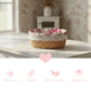 Woven basket with floral liner on a wooden surface, with decorative icons and text below.