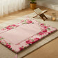 Fleur Haven Padded Prayer Rug floral pink design on tatami mat with wooden stand and candle background