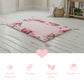 Floral-patterned mat on a wooden floor with product features displayed below.