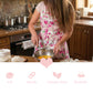 Graphic with a person whisking eggs in a pink floral apron above icons for soft, durable, gabardine, and breathable.