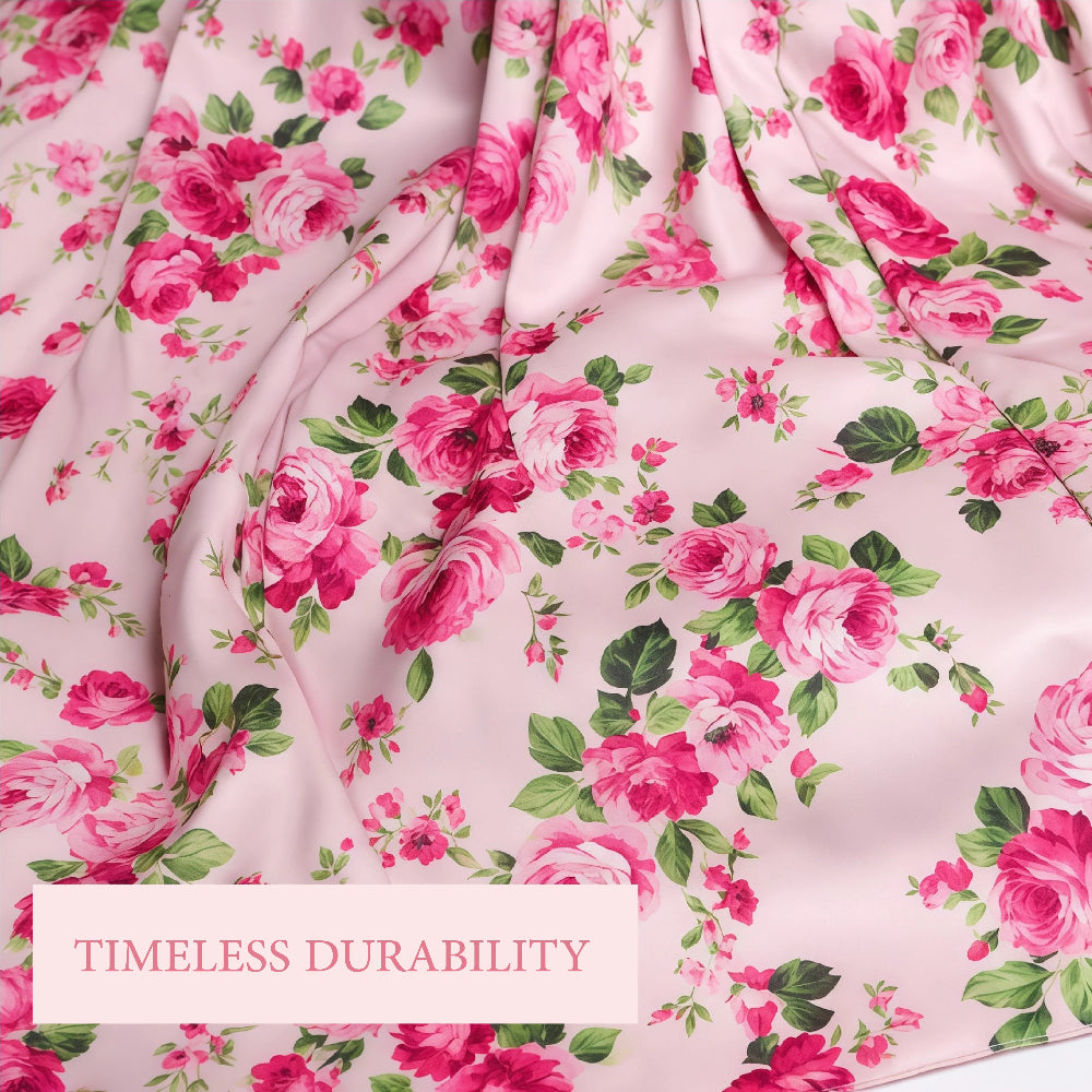 Close-up of the Fleur Isdal prayer dress fabric featuring a pink rose pattern, with a pink text overlay that reads "TIMELESS DURABILITY."