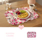 Breakfast on a floral placemat above a pink heart, the text "INVITING CHARM," and a product graphic.