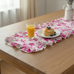 Floral table runner with pancakes and orange juice on a wooden table